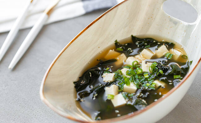 japanese miso soup in a white bowl on the table G43J2U6